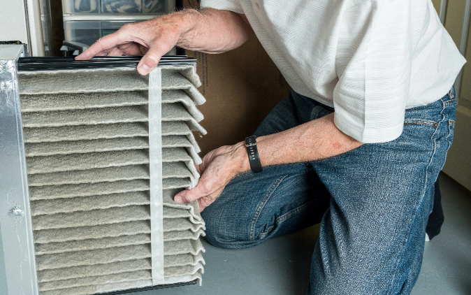 Man Cleaning Furnace Filter