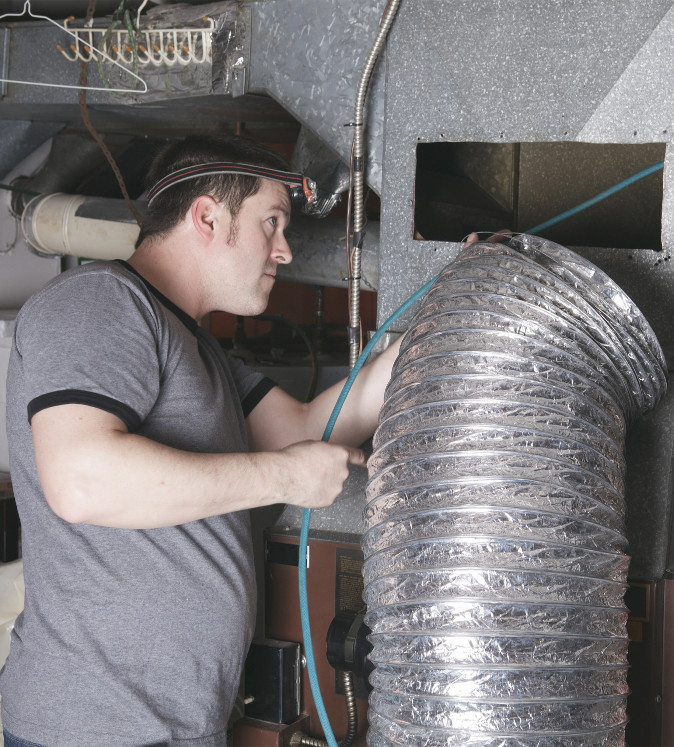 Man working on Furnace Replacement in Calgary